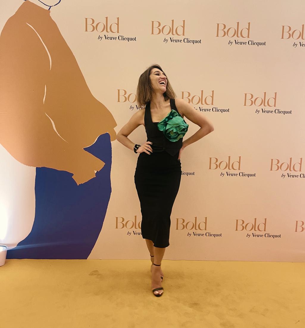 Irina laughing in front of a Bold backdrop