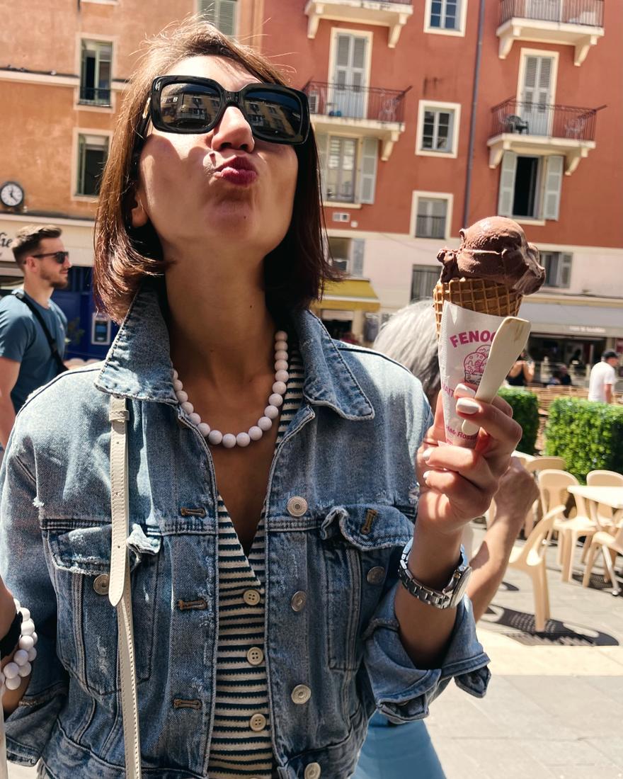 Irina blowing a kiss, ice cream cone in hand